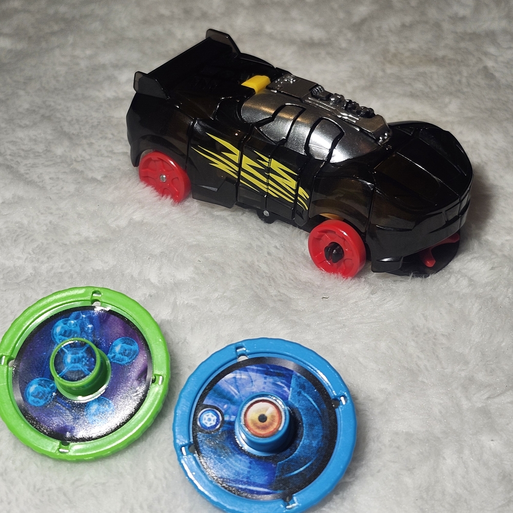 Black and Red Toy Car with Spinning Tops